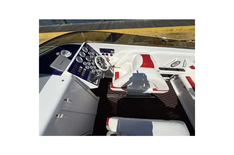 Slide: The Image of Cockpit of a 2000 Fountain 47 Lightning boat with white and red seating. - 44