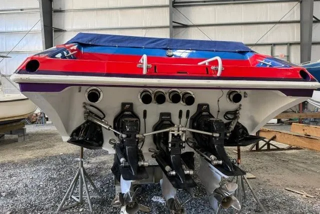 Slide: The Image of Rear view of a 2000 Fountain 47 Lightning boat in a storage facility. - 8