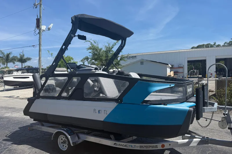 The Image of 2022 Sea-Doo Switch Sport 18 on trailer, parked outdoors under clear blue sky. - 1
