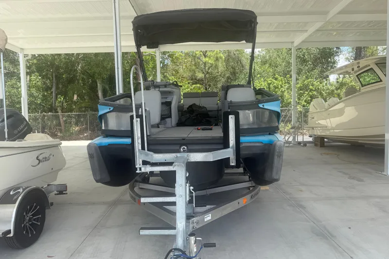Slide: The Image of 2022 Sea-Doo Switch Sport 18 pontoon boat on trailer in covered storage area. - 4