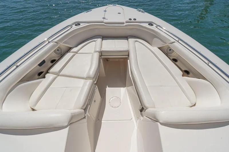 Slide: The Image of 2016 Grady-White Freedom 335 boat interior with spacious seating on calm water. - 12