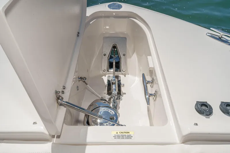 Slide: The Image of Anchor compartment of 2016 Grady-White Freedom 335 boat, open hatch, marine hardware visible. - 13