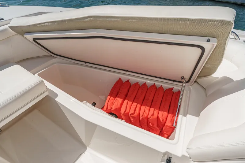 Slide: The Image of Storage compartment with life jackets on a 2016 Grady-White Freedom 335 boat. - 15
