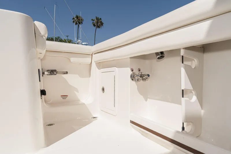 Slide: The Image of 2016 Grady-White Freedom 335 boat interior, featuring sleek white design and utility fixtures. - 17