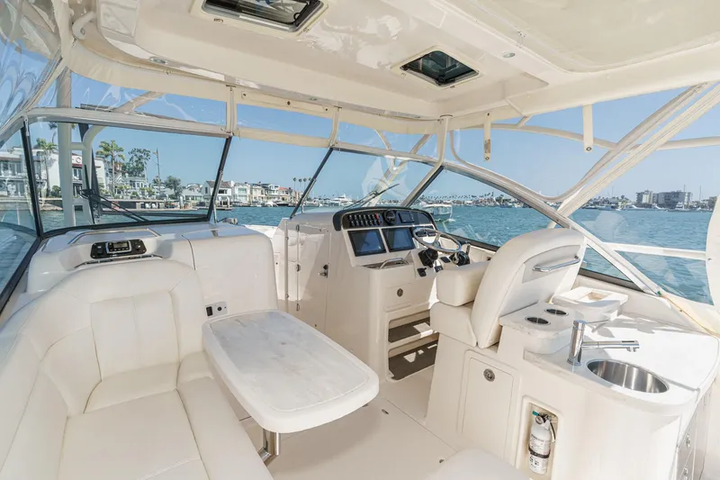 Slide: The Image of 2016 Grady-White Freedom 335 boat interior with luxurious seating and modern controls. - 18