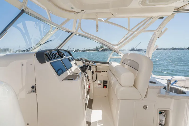 Slide: The Image of 2016 Grady-White Freedom 335 boat interior with helm, seating, and ocean view. - 19