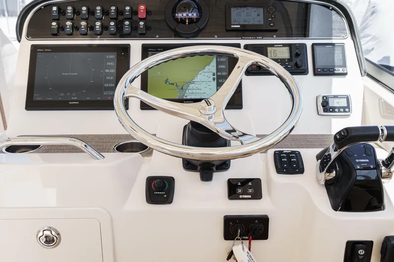 Slide: The Image of Helm of 2016 Grady-White Freedom 335 boat with advanced navigation controls and displays. - 20