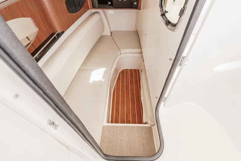 Slide: The Image of 2016 Grady-White Freedom 335 cabin interior with cushioned seating and wooden flooring. - 31