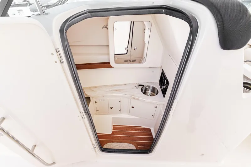 Slide: The Image of 2016 Grady-White Freedom 335 cabin interior with sink and storage. - 35