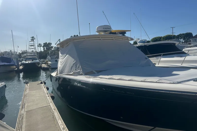 Slide: The Image of 2016 Grady-White Freedom 335 boat docked, covered with a protective tarp. - 37