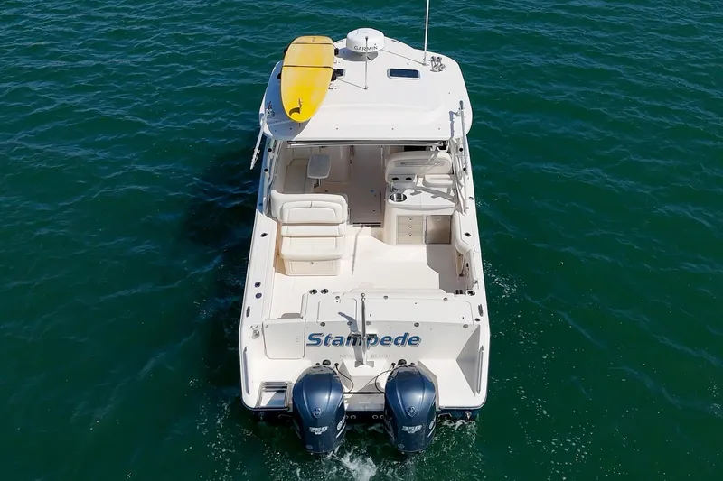 Slide: The Image of 2016 Grady-White Freedom 335 boat with dual engines and a yellow kayak on deck. - 38