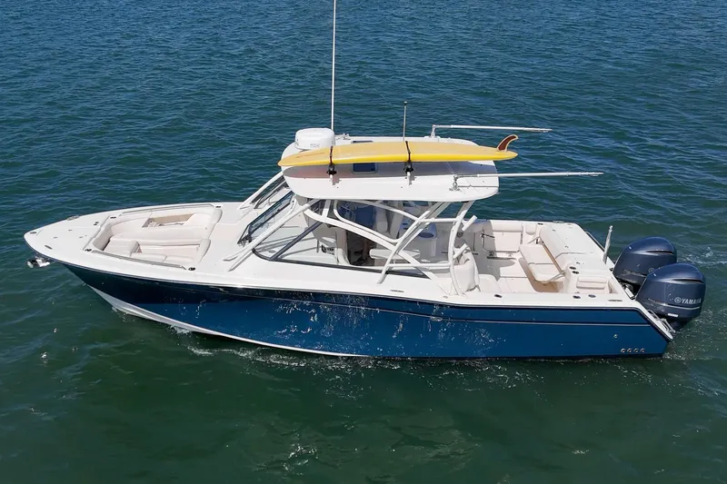 Slide: The Image of 2016 Grady-White Freedom 335 boat with dual Yamaha engines on open water. - 5