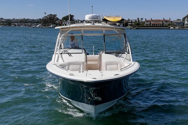 Slide: The Image of 2016 Grady-White Freedom 335 boat cruising on blue water. - 9