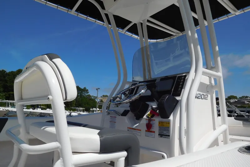 Slide: The Image of 2023 Robalo R202 Explorer boat interior with steering console and seating. - 4