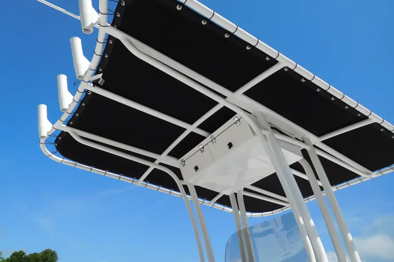 Slide: The Image of 2023 Robalo R202 Explorer T-top against clear blue sky. - 5