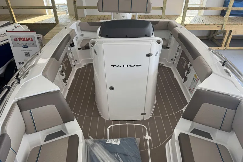 Slide: The Image of 2026 Tahoe 2150 CC boat interior with seating and console, displayed at Yamaha Marine Service. - 2