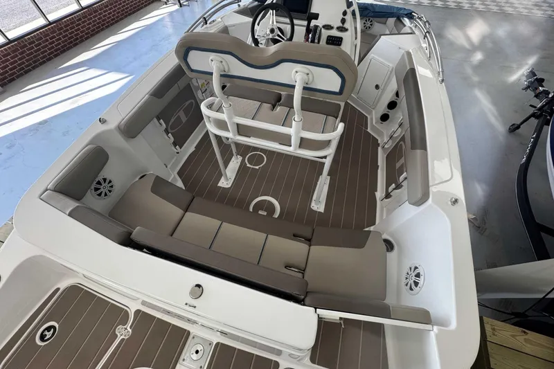 Slide: The Image of 2026 Tahoe 2150 CC boat interior with beige seating and modern helm design. - 3