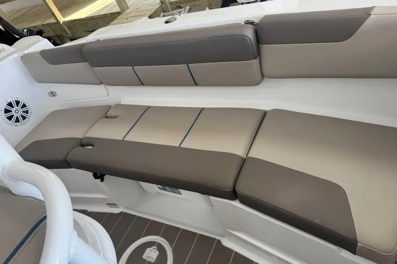 Slide: The Image of 2026 Tahoe 2150 CC boat interior with cushioned seating and speaker. - 5