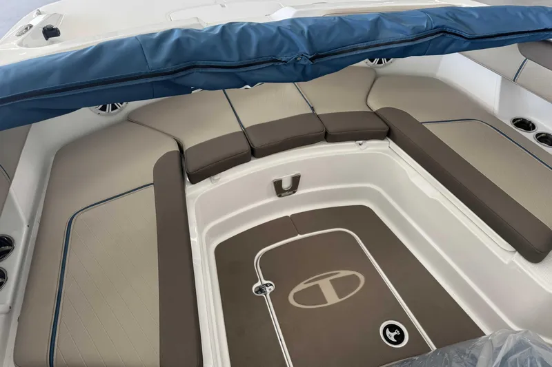 Slide: The Image of Interior seating of 2026 Tahoe 2150 CC boat with cushioned seats and blue cover. - 7