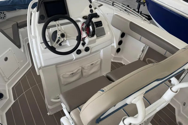 Slide: The Image of 2026 Tahoe 2150 CC boat interior with steering wheel and seating area. - 8