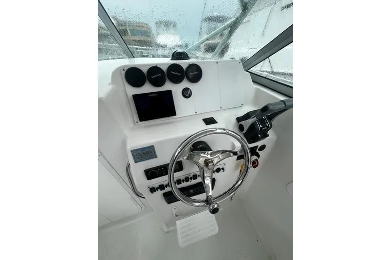Slide: The Image of 2007 Sea Pro 270 Walk Around boat helm with steering wheel and instrument panel. - 2