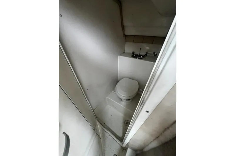 Slide: The Image of 2007 Sea Pro 270 Walk Around boat bathroom with toilet and sink. - 3