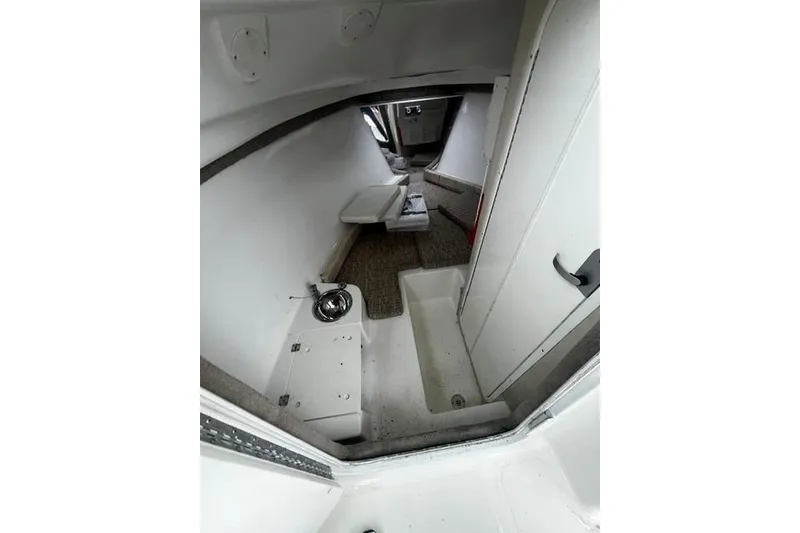 Slide: The Image of Interior cabin of 2007 Sea Pro 270 Walk Around boat, featuring compact design and seating. - 4