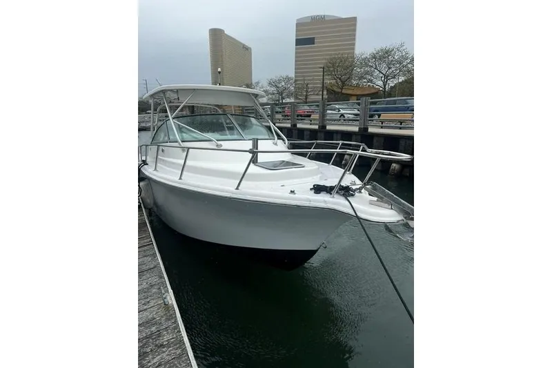 Slide: The Image of 2007 Sea Pro 270 Walk Around boat docked in marina, overcast sky. - 5