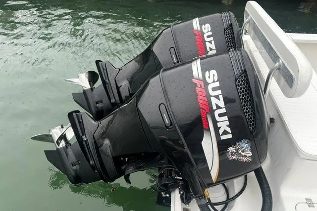 Slide: The Image of Twin Suzuki outboard motors on a 2007 Sea Pro 270 Walk Around boat. - 6