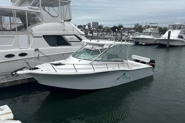 Slide: The Image of 2007 Sea Pro 270 Walk Around boat docked in a marina, surrounded by other vessels. - 7