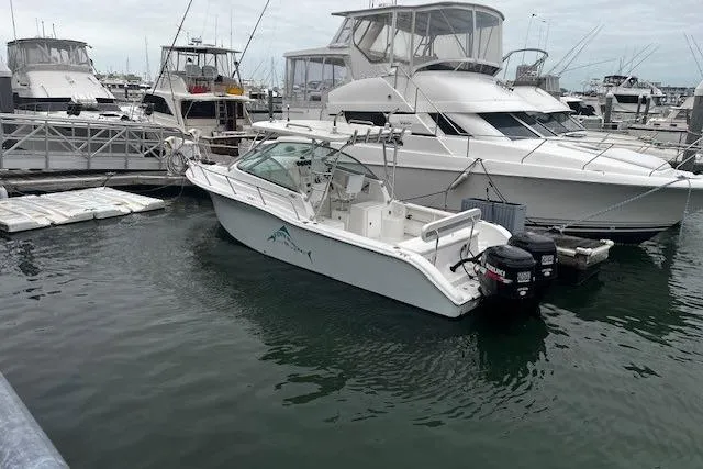 Slide: The Image of 2007 Sea Pro 270 Walk Around boat docked in a marina with other vessels. - 8