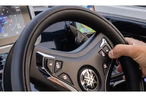 Slide: The Image of Steering wheel of 2026 Yamaha Boats 252SD with control buttons and dashboard display. - 7
