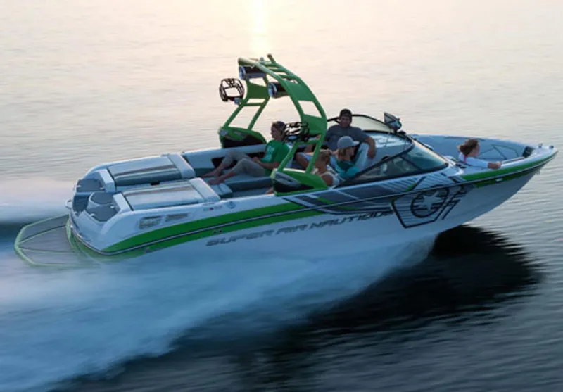 Slide: The Image of Manufacturer Provided Image: 2013 Nautique Super Air Nautique 230 speedboat cruising on water with passengers. - 2