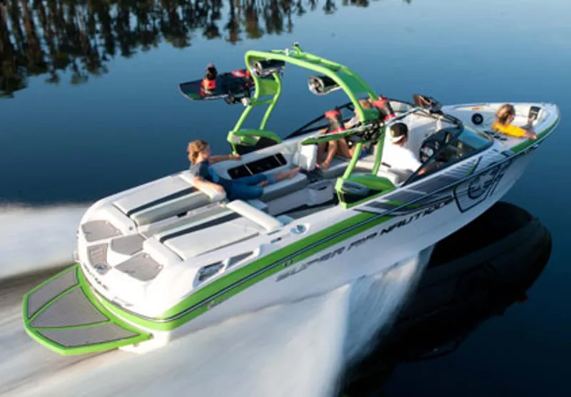 Slide: The Image of Manufacturer Provided Image: 2013 Nautique Super Air Nautique 230 speedboat on a calm lake. - 3
