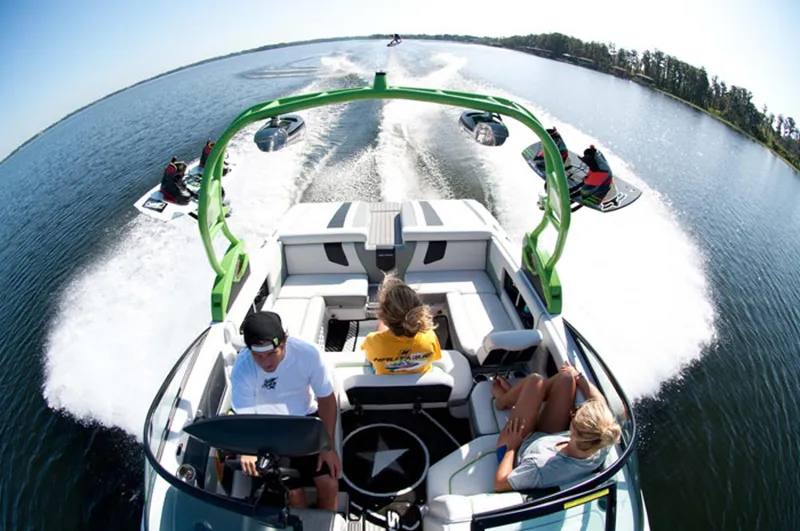 Slide: The Image of Manufacturer Provided Image: 2013 Nautique Super Air Nautique 230 on a lake with wakeboarders. - 4