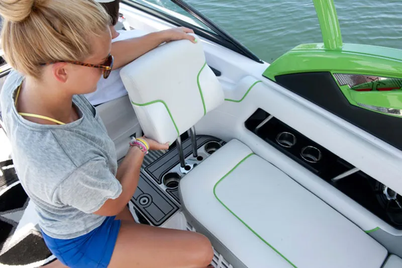 Slide: The Image of Manufacturer Provided Image: Woman adjusting seat on 2013 Nautique Super Air Nautique 230 boat. - 6