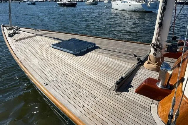 Slide: The Image of Sleek 2006 Morris 36 sailboat with wooden deck, docked on calm waters. - 15
