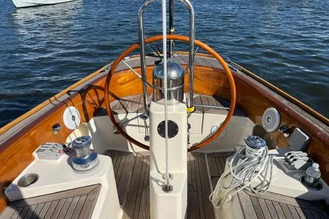 Slide: The Image of Steering wheel of a 2006 Morris 36 sailboat on calm water. - 17