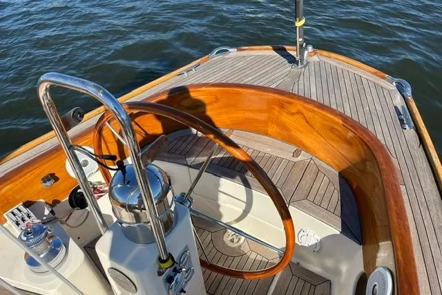 Slide: The Image of Steering wheel of a 2006 Morris 36 sailboat with wooden accents on deck. - 18