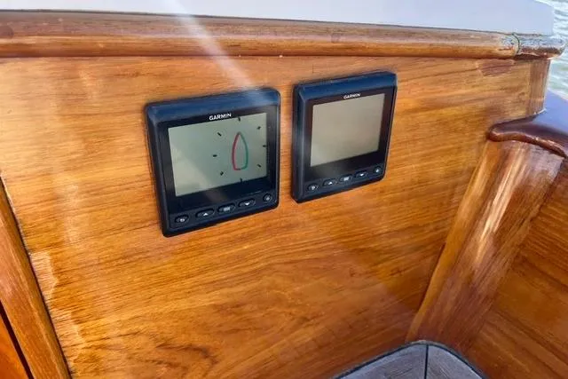 Slide: The Image of Wooden dashboard with Garmin navigation displays on a 2006 Morris 36 boat. - 21