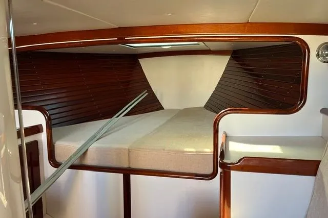 Slide: The Image of Interior cabin of a 2006 Morris 36 sailboat with wooden accents and cozy bedding. - 24