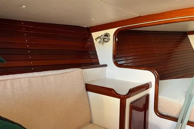 Slide: The Image of Interior of a 2006 Morris 36 boat with polished wood and beige upholstery. - 25