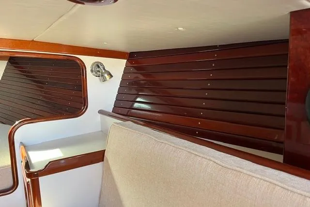 Slide: The Image of Interior of a 2006 Morris 36 boat with polished wood paneling and beige upholstery. - 26