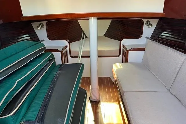 Slide: The Image of Interior of a 2006 Morris 36 sailboat with cushions and wooden accents. - 28