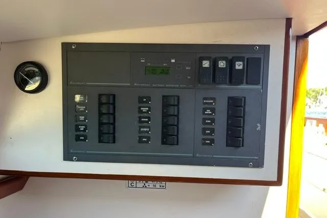 Slide: The Image of Electrical control panel on a 2006 Morris 36 boat, featuring switches and gauges. - 30