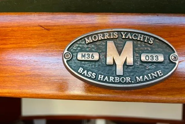 Slide: The Image of Plaque of 2006 Morris 36 yacht, Bass Harbor, Maine, on polished wood surface. - 33