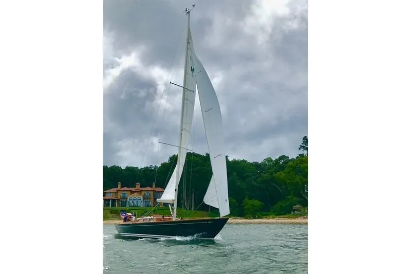 Slide: The Image of Sailing yacht Morris 36 (2006) on water near shoreline with cloudy sky. - 4