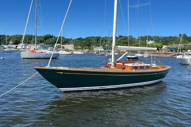 Slide: The Image of Sailboat on calm water, Morris 36 model, 2006, with scenic harbor background. - 8