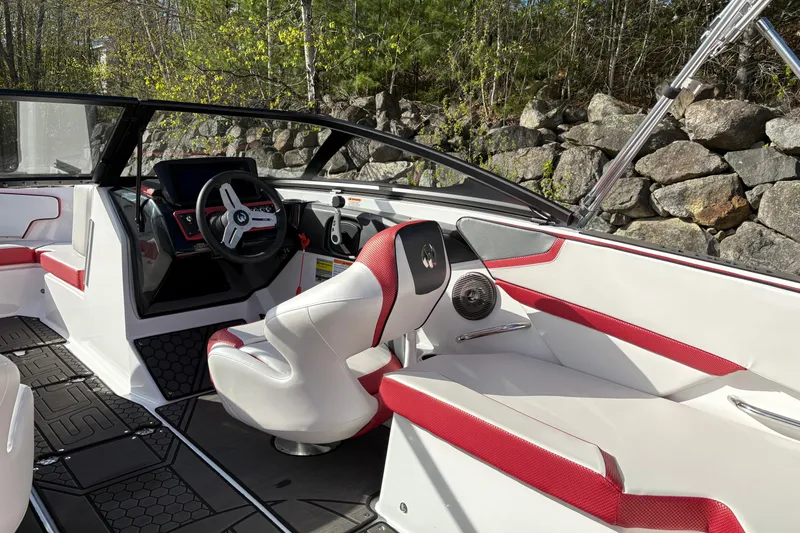 Slide: The Image of Interior of 2023 Scarab 215 ID boat with red and white seating, steering wheel, and dashboard. - 10