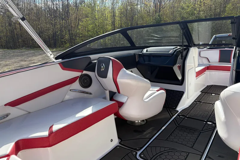 Slide: The Image of 2023 Scarab 215 ID boat interior with red and white seating, sleek design, and spacious layout. - 13